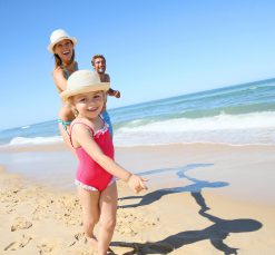 Family enjoy a day at the beach in the sun