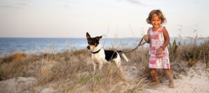 girl with dog on beach