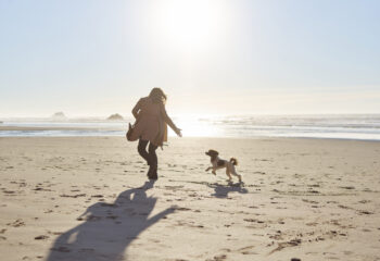 Woman and a Dog Running on Beach-spring break in cornwall